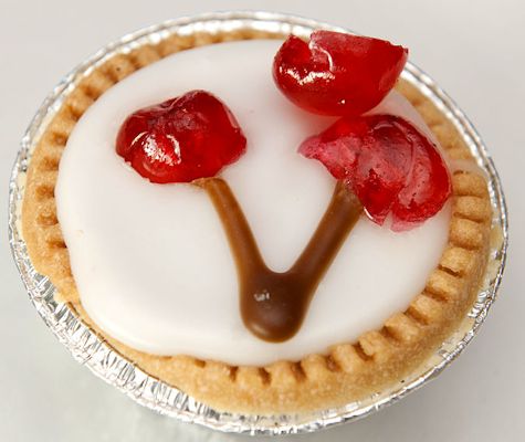 An almond-flavoured Bakewell tart, decorated with Marascino cherries.