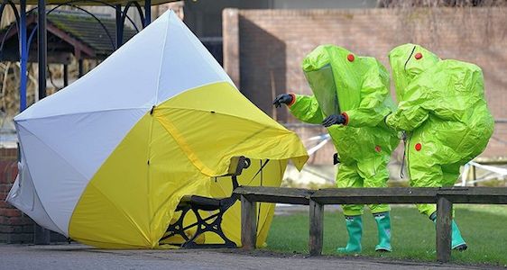 Specialists in hazmat suits inspecting the forensic covering the bench in Salisbury where the Skripals were found