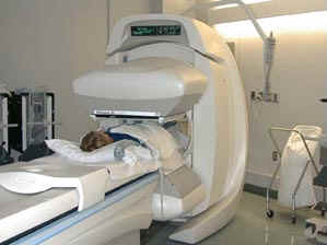 A gamma camera scanning a patient (used without permission)