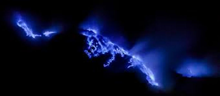 Volcano Kawah Ijen erupting at night.