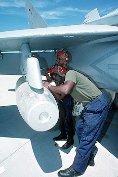 A Mark 77 bomb being loaded on an F/A-18 Hornet, 1993.